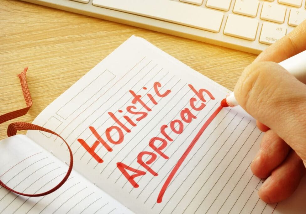 Holistic approach written in notebook.