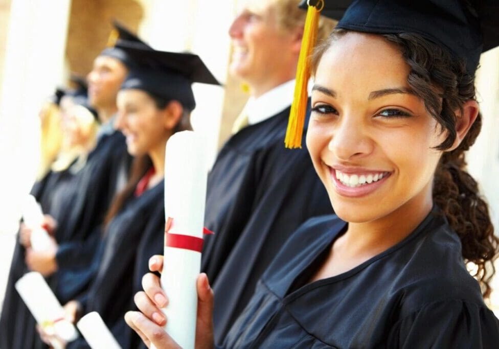 Happy graduate holding diploma at ceremony.